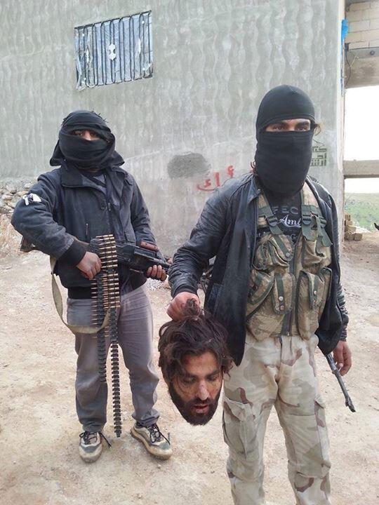 Jabhat an Nusra from Al Numr checkpoint with a beheaded Rafidi